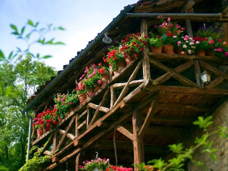 Saint-Cirq-Lapopie France, Wooden balcony embellished with flowers