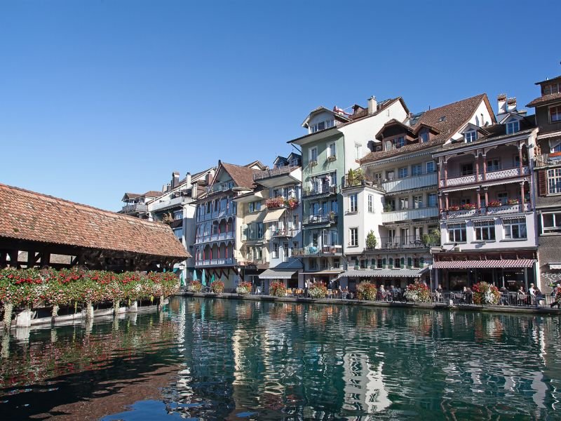 River Aare, wooden bridge, and houses in Old Town Thun, Switzerland
